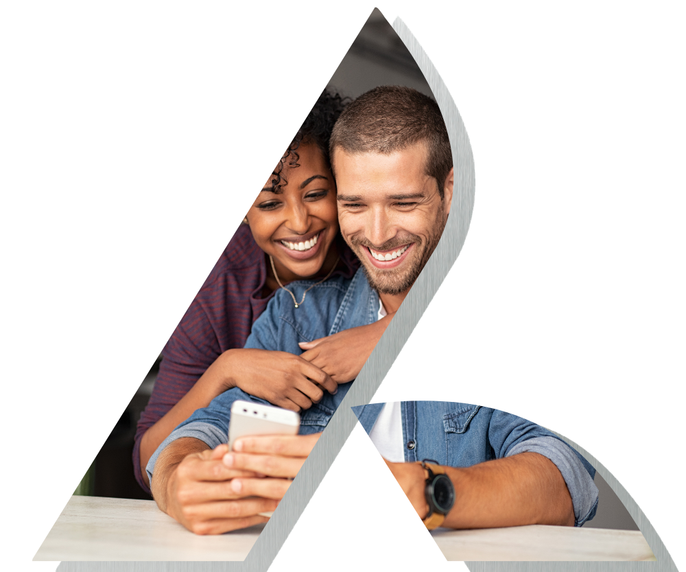 Man and woman smiling looking at phone