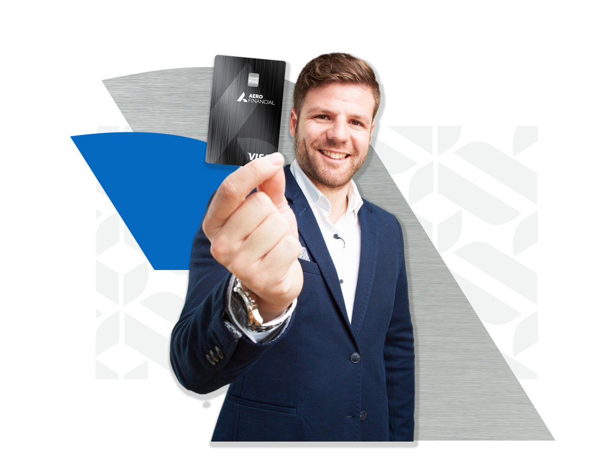 Business man in a blue suit holding an AERO Business Credit Card while smiling