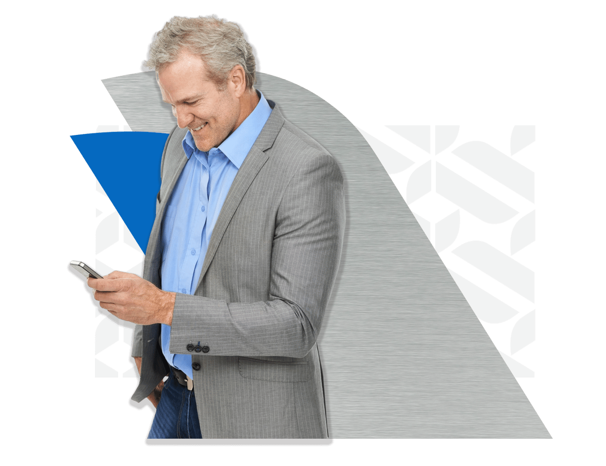 Business man looking down at his cell phone wearing a gray suit. Business man looking down at his cell phone wearing a gray suit.