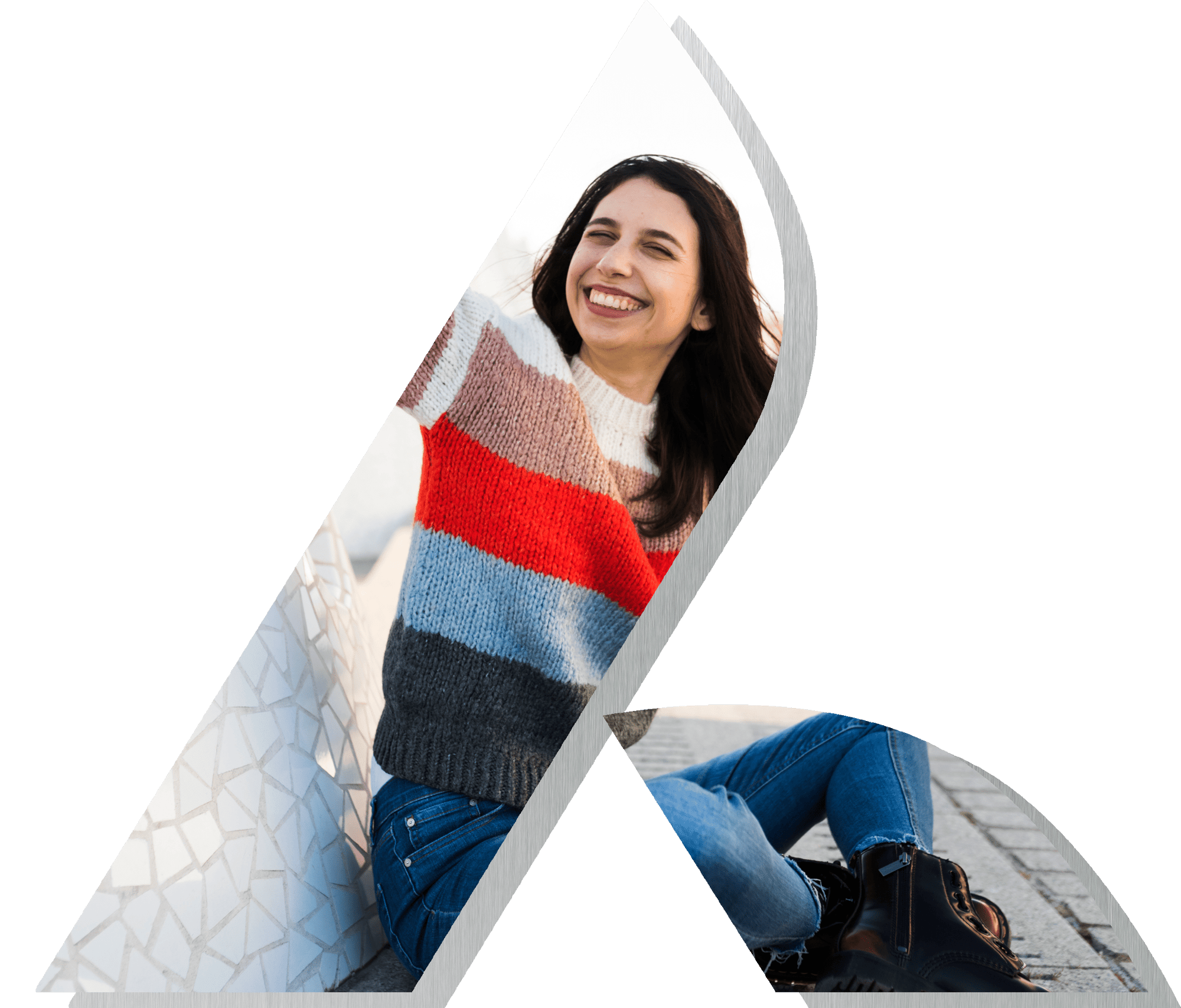 Woman with brown hair smiling and wearing a bright striped sweater