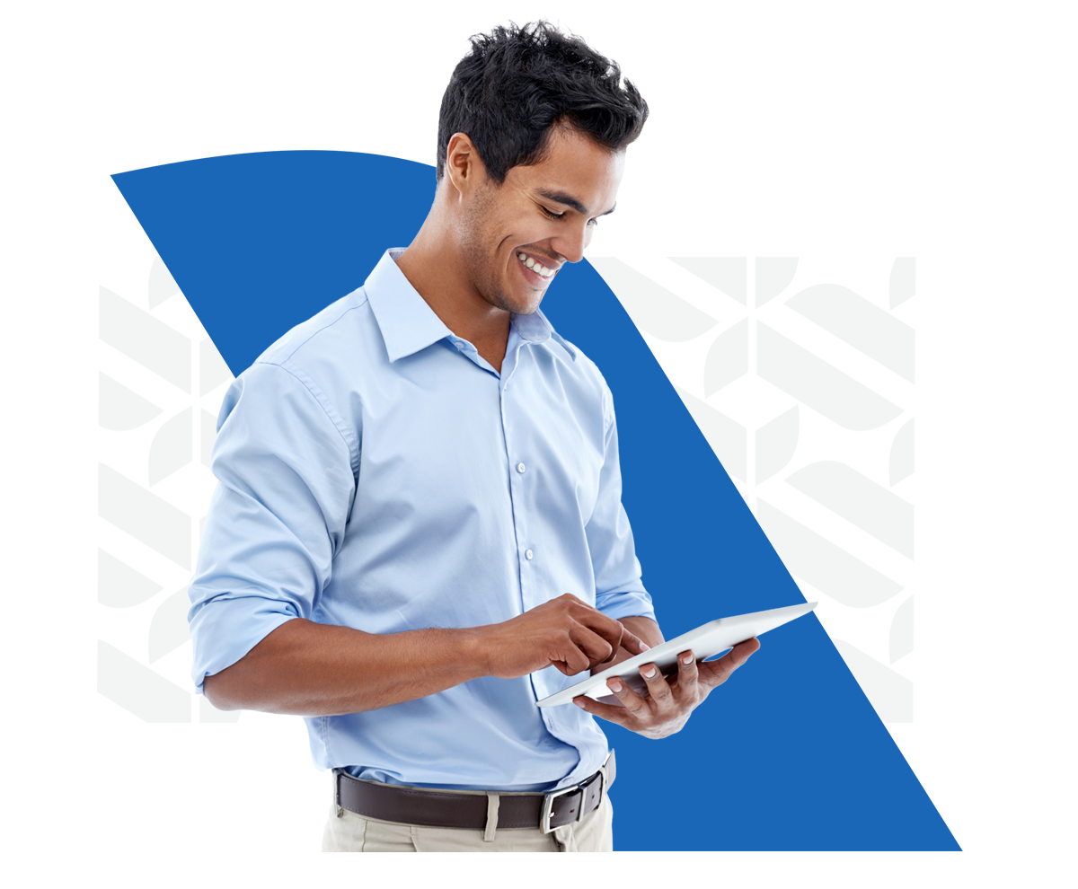 Business owner in blue button up shirt looking down at his tablet in his hands.