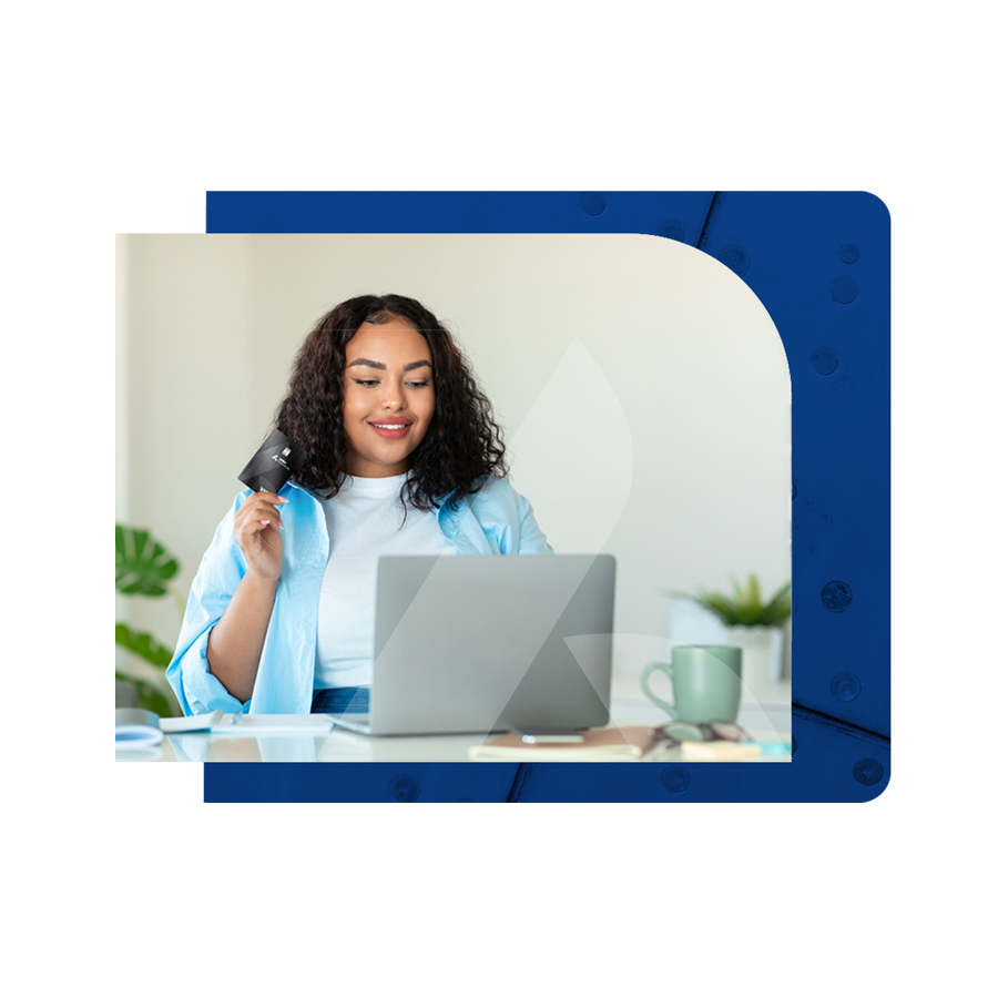 Woman-in-jean-shirt-holding-up-a-business-credit-card